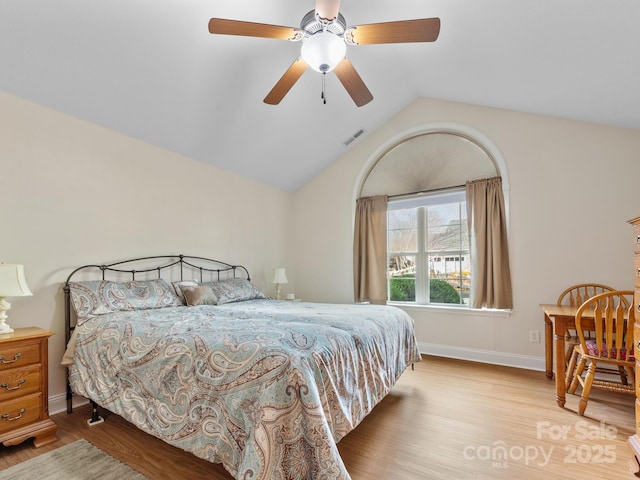 bedroom featuring ceiling fan, vaulted ceiling, and light wood-type flooring