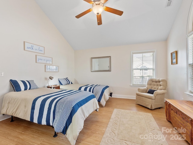 bedroom featuring lofted ceiling, light hardwood / wood-style floors, and ceiling fan