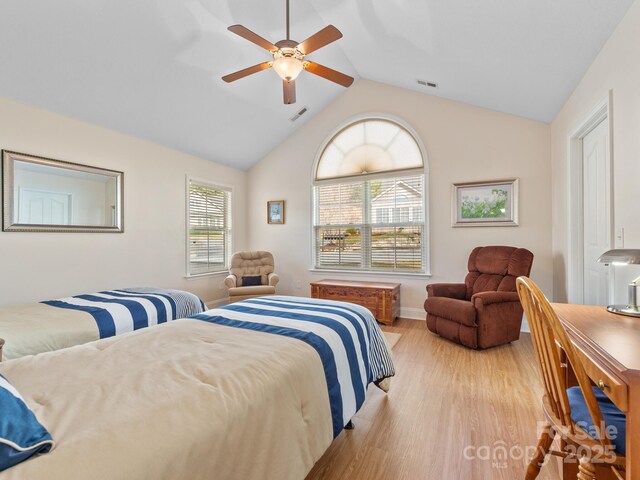 bedroom with ceiling fan, lofted ceiling, and light hardwood / wood-style flooring