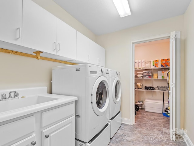 laundry area featuring cabinets, sink, and washing machine and dryer