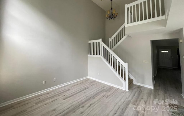 11907 Maria Ester Ct, Charlotte, NC 28277 - stairway with baseboards, a high ceiling, wood finished floors, and an inviting chandelier