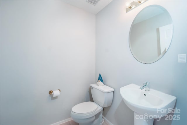 11907 Maria Ester Ct, Charlotte, NC 28277 - half bathroom featuring baseboards, visible vents, toilet, and a sink