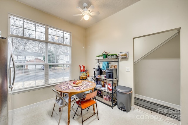 recreation room with ceiling fan, plenty of natural light, and a textured ceiling