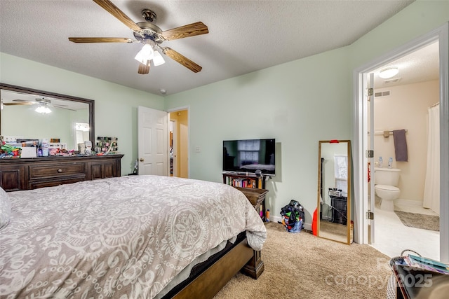 carpeted bedroom featuring ceiling fan and a textured ceiling