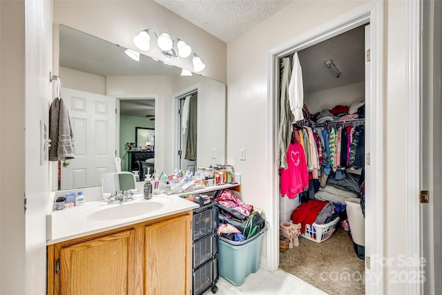 bathroom featuring vanity and a textured ceiling