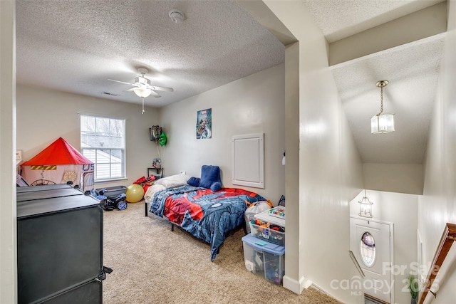 bedroom featuring ceiling fan, a textured ceiling, and carpet flooring