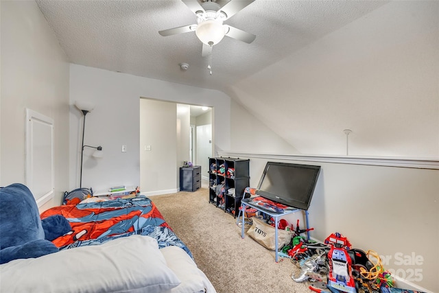 carpeted bedroom with ceiling fan, lofted ceiling, and a textured ceiling