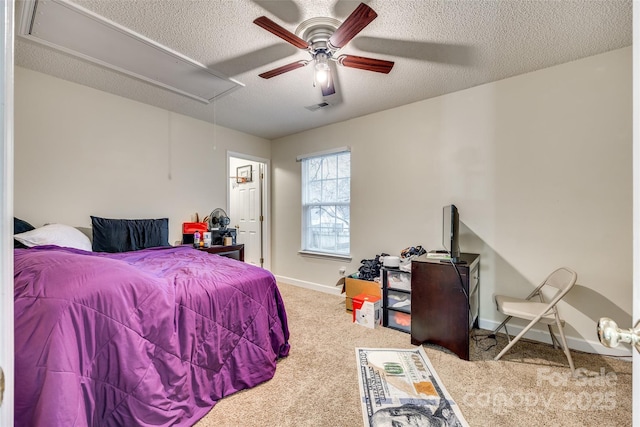 carpeted bedroom with ceiling fan and a textured ceiling