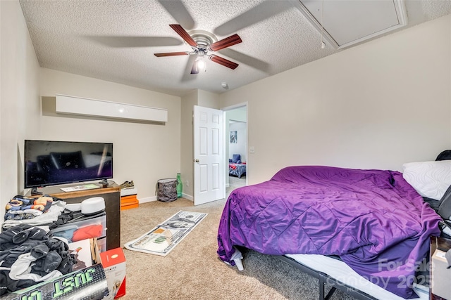 bedroom featuring ceiling fan, carpet flooring, and a textured ceiling