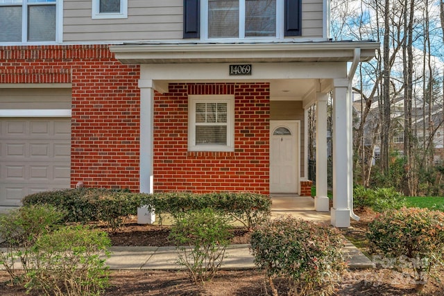 doorway to property with a garage