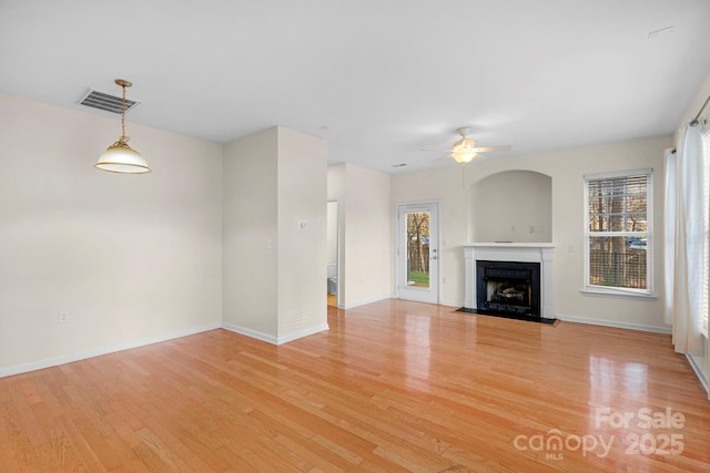 unfurnished living room featuring ceiling fan and light hardwood / wood-style floors