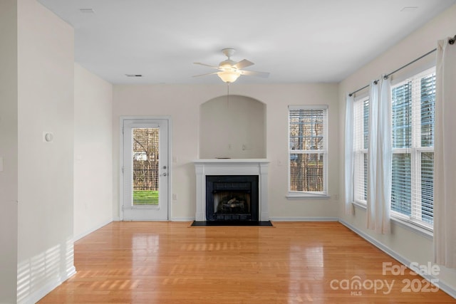 unfurnished living room with light hardwood / wood-style floors and ceiling fan