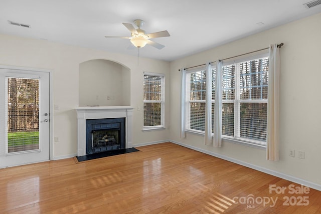 unfurnished living room featuring wood-type flooring and ceiling fan