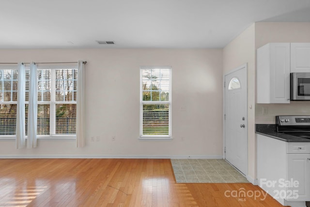 kitchen featuring white cabinetry, light hardwood / wood-style flooring, and stainless steel appliances