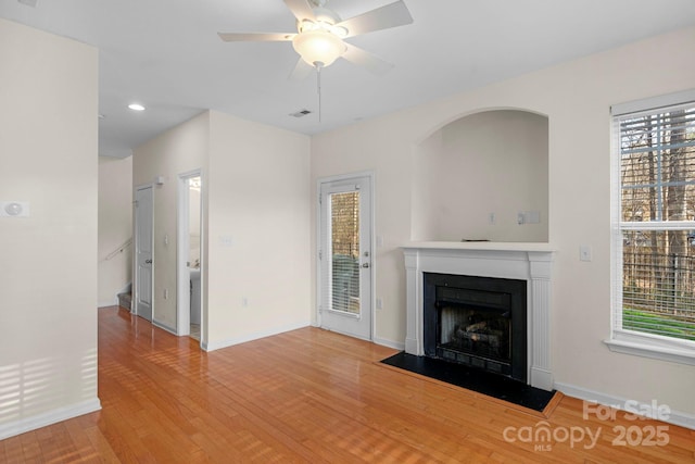 unfurnished living room with ceiling fan and light hardwood / wood-style flooring