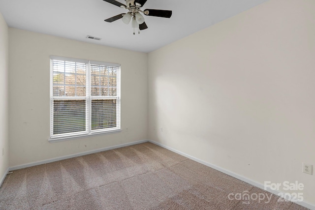 carpeted spare room with ceiling fan