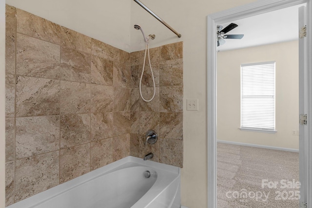 bathroom with ceiling fan and tiled shower / bath