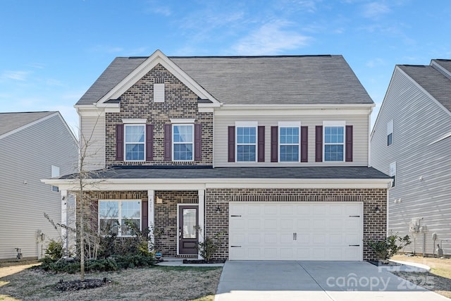 view of front of home featuring a garage, roof with shingles, concrete driveway, and brick siding