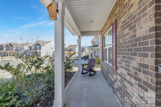 view of patio / terrace featuring a residential view and a porch