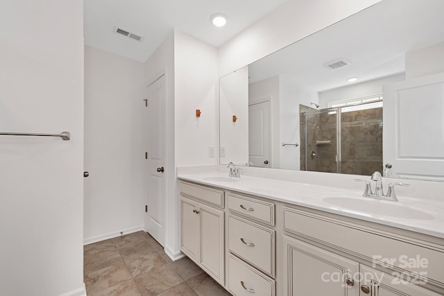 full bath with double vanity, a sink, and visible vents