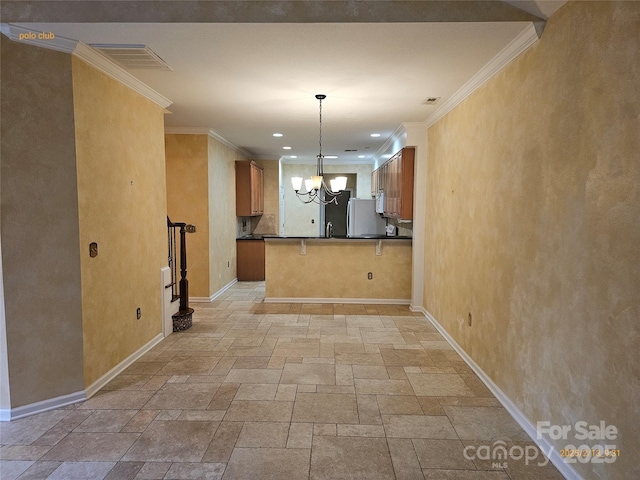 kitchen featuring a breakfast bar, an inviting chandelier, ornamental molding, decorative light fixtures, and kitchen peninsula