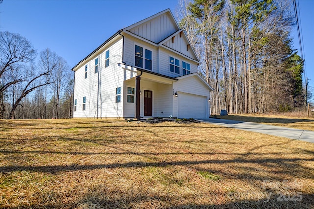 view of front of house featuring a garage, concrete driveway, board and batten siding, and a front yard