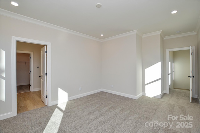 unfurnished room featuring crown molding, carpet, baseboards, and recessed lighting