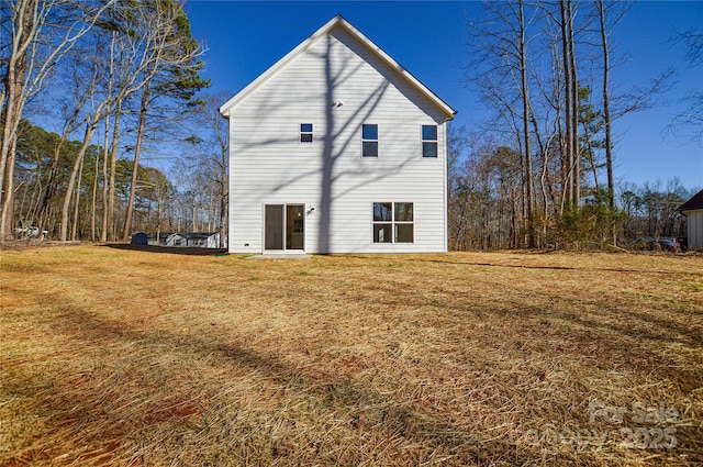 back of property featuring a lawn