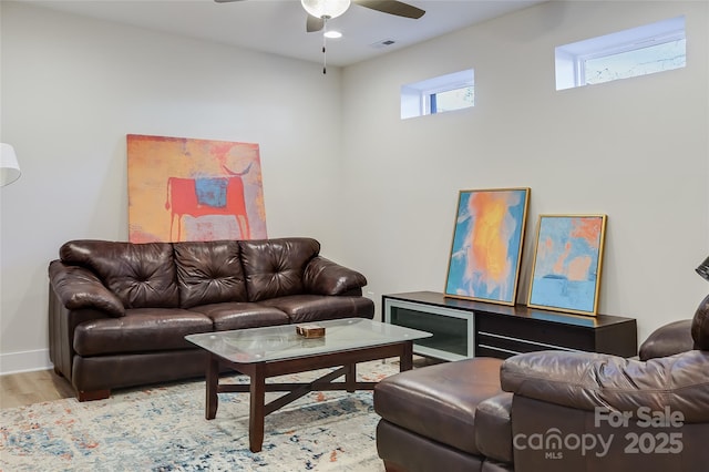 living room with ceiling fan and light wood-type flooring