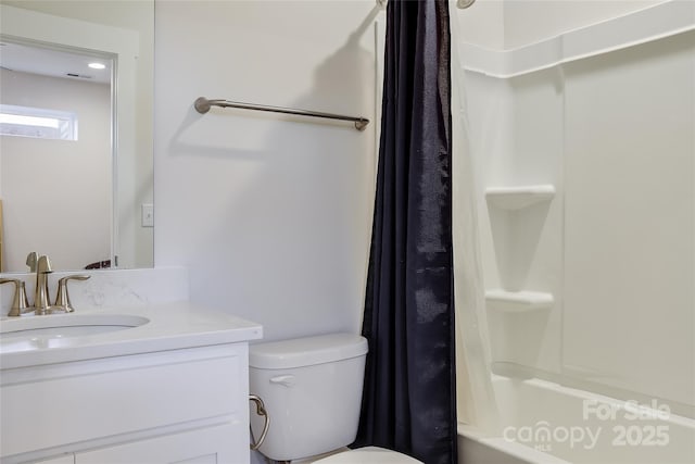 full bathroom with vanity, shower / tub combo, and toilet