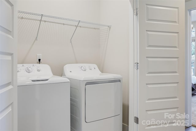 clothes washing area featuring washing machine and clothes dryer