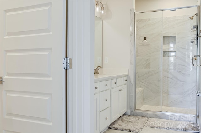 bathroom featuring walk in shower and vanity