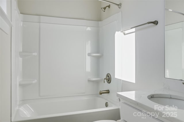 full bathroom with vanity, toilet, and  shower combination