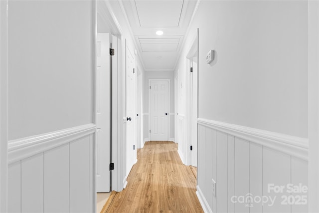 hall featuring ornamental molding and light hardwood / wood-style floors