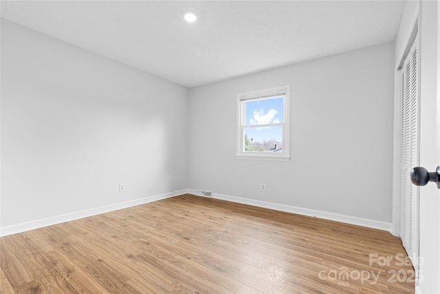 unfurnished bedroom featuring hardwood / wood-style flooring and a closet