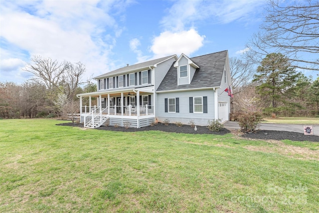 view of front of house with a porch, a garage, and a front lawn