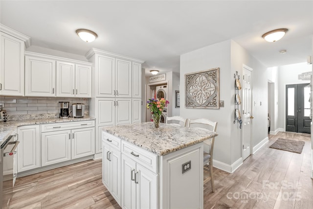 kitchen featuring a kitchen bar, white cabinetry, and a center island