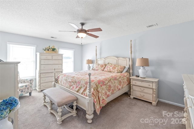 bedroom featuring visible vents, ceiling fan, light carpet, and baseboards