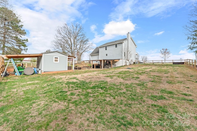 view of yard with an outbuilding and fence