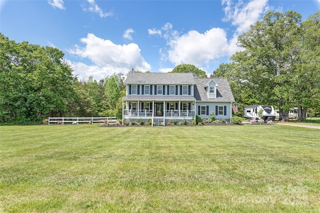 view of front of home with a chimney, fence, a porch, and a front yard