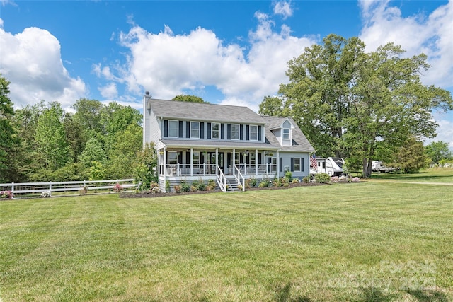 colonial home with fence, a porch, and a front yard