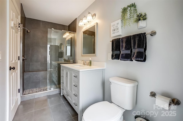 full bathroom with vanity, a stall shower, tile patterned flooring, and toilet