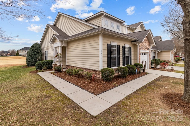 view of front facade with a garage and a front lawn