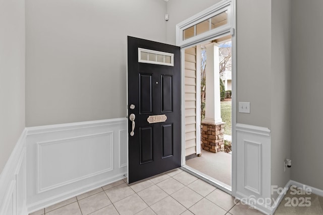 entryway with light tile patterned flooring