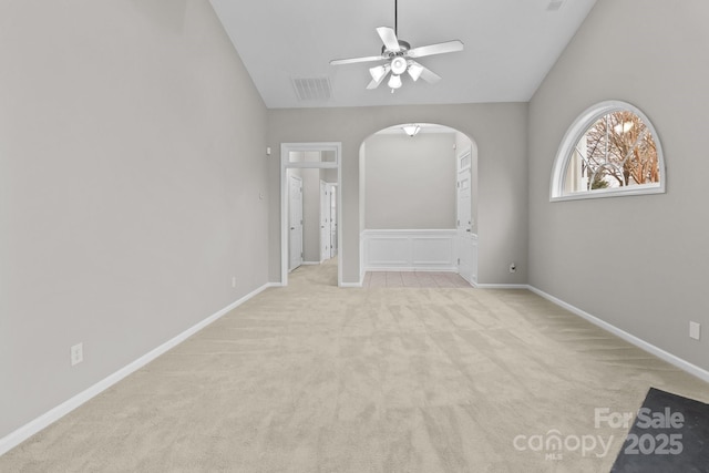 carpeted spare room with lofted ceiling and ceiling fan