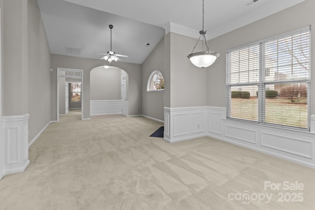 interior space with ceiling fan, light colored carpet, vaulted ceiling, and a wealth of natural light