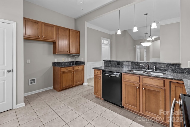 kitchen featuring dark stone countertops, black dishwasher, sink, and decorative light fixtures