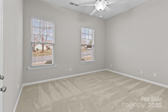 carpeted spare room featuring ceiling fan