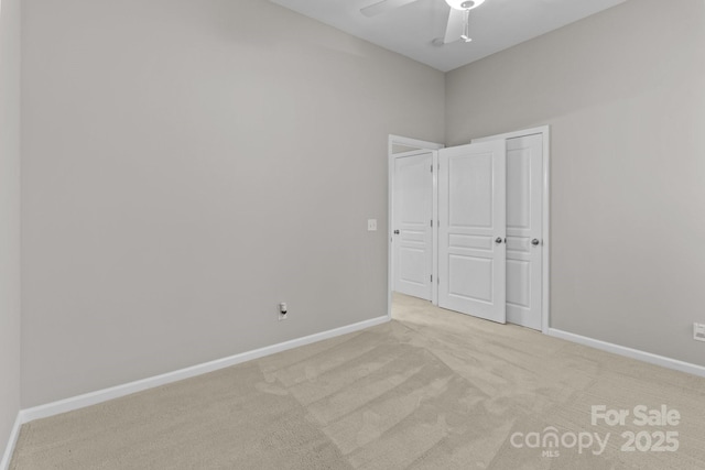 unfurnished bedroom with light colored carpet and ceiling fan