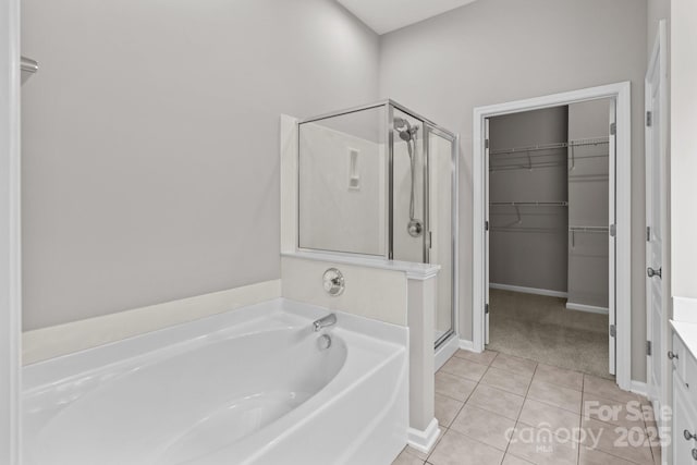 bathroom featuring shower with separate bathtub, tile patterned floors, and vanity